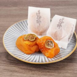 Japanese Wakayama Anpogaki (Half-Dried Persimmons) on plate Japanese Wakayama Anpogaki (Half-Dried Persimmons) on plate